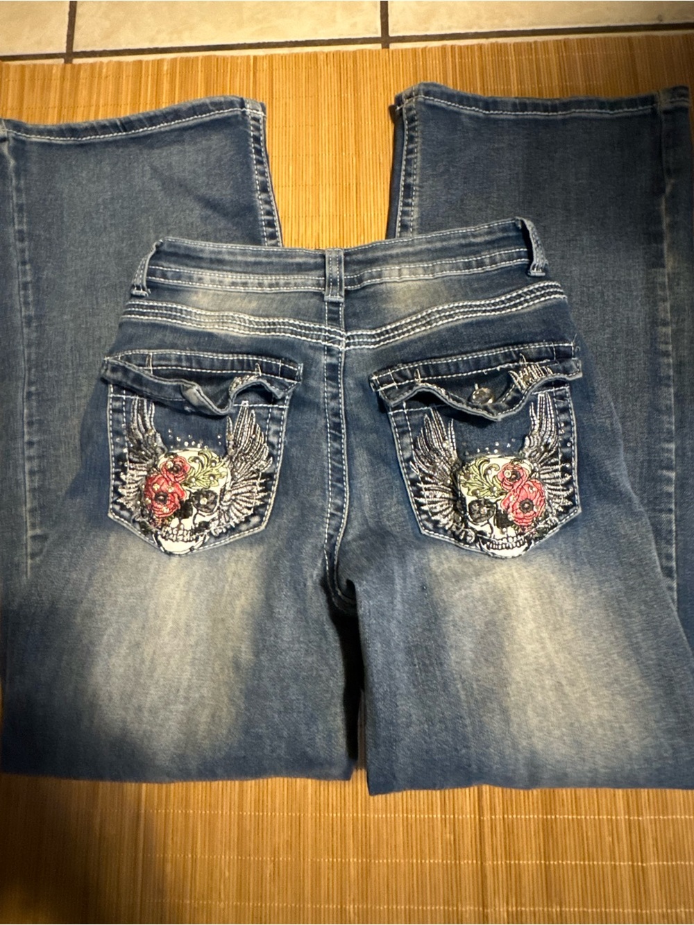 Women Blue Embroidered Boot Cut Jeans with Floral Skull Pocket Accents
